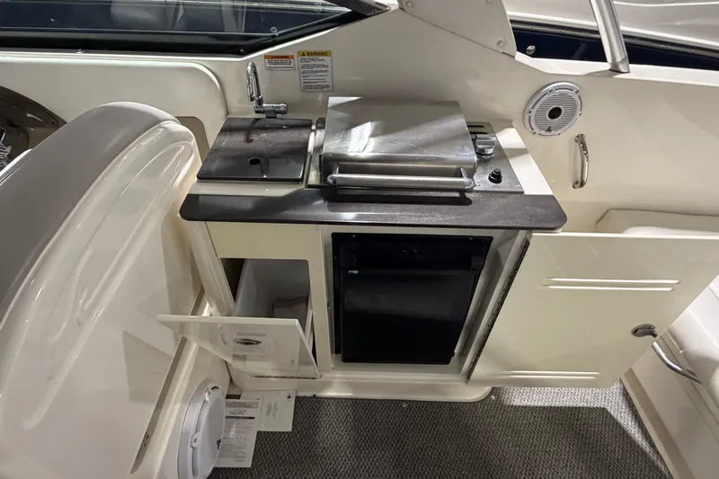 Slide: The Image of 2012 Sea Ray 300 SLX boat interior with kitchenette and sink. - 34