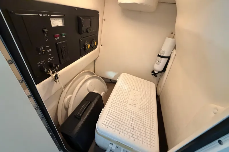 Slide: The Image of Interior of 2012 Sea Ray 300 SLX boat with control panel and storage area. - 37