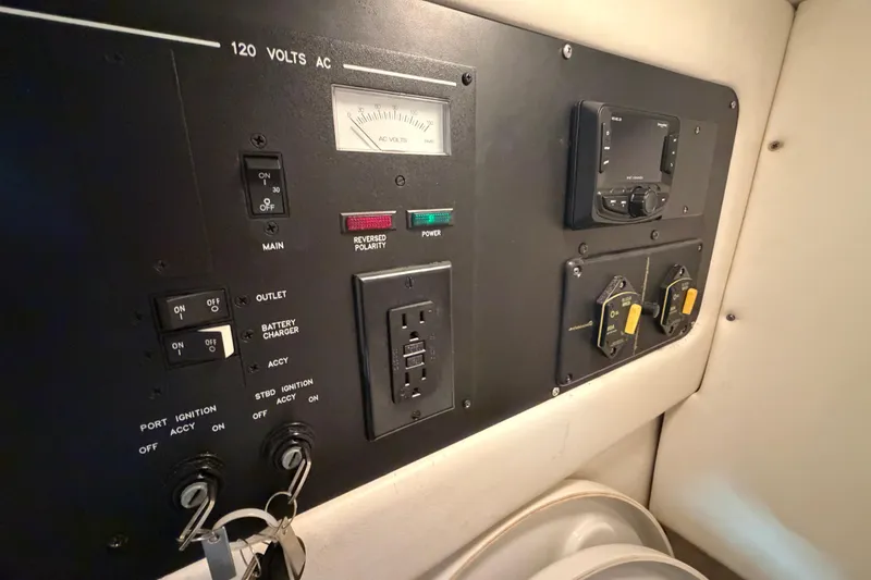 Slide: The Image of Control panel of a 2012 Sea Ray 300 SLX boat, featuring various switches and gauges. - 38