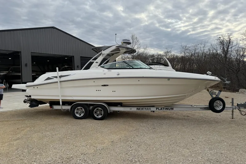 Slide: The Image of 2012 Sea Ray 300 SLX boat on trailer in front of warehouse. - 8