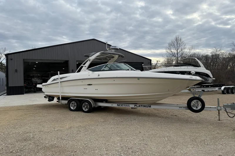 Slide: The Image of 2012 Sea Ray 300 SLX boat on trailer outside storage facility. - 9