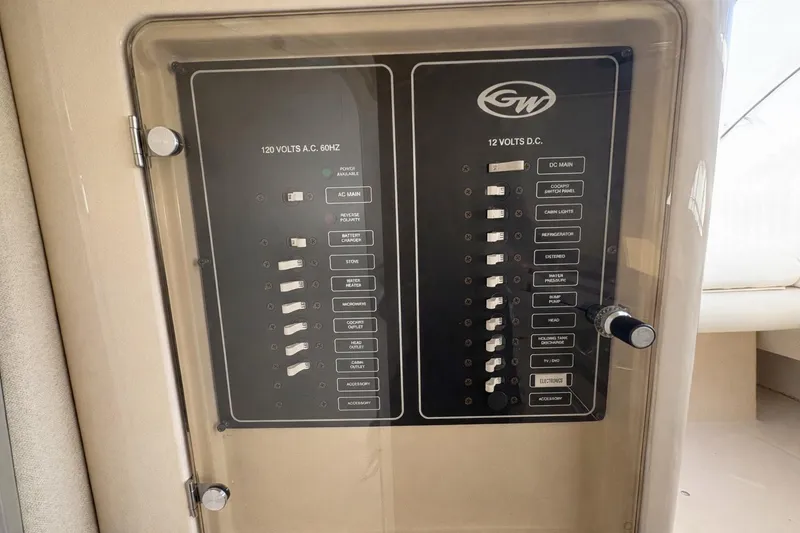 Slide: The Image of Electrical panel on a 2003 Grady-White Marlin 300 boat, featuring AC and DC switches. - 11