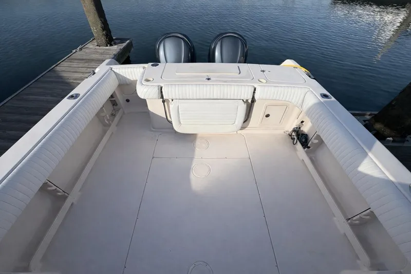 Slide: The Image of 2003 Grady-White Marlin 300 boat deck with twin engines at dock. - 3