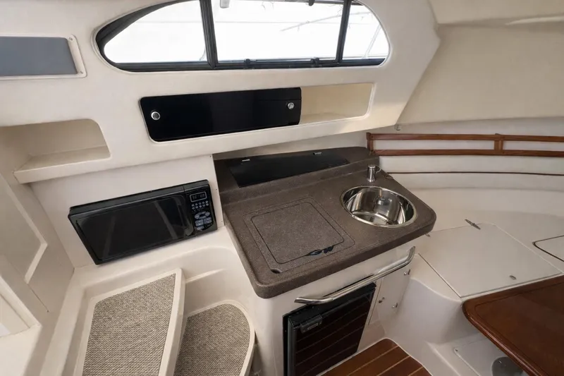 Slide: The Image of 2003 Grady-White Marlin 300 boat interior with kitchenette and seating area. - 8