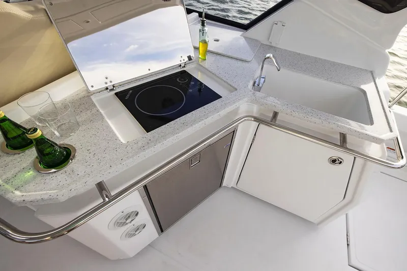 Slide: The Image of Manufacturer Provided Image: Modern kitchenette on 2026 Aquila 36 Sport yacht with sink, stove, and countertop. - 12