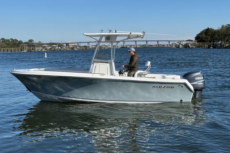 The Image of 2005 Sailfish 218 CC boat on water with Yamaha engine, man steering. - 0