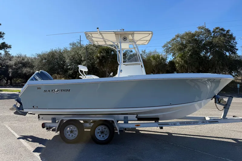 Slide: The Image of 2005 Sailfish 218 CC boat on trailer, parked outdoors under clear sky. - 10