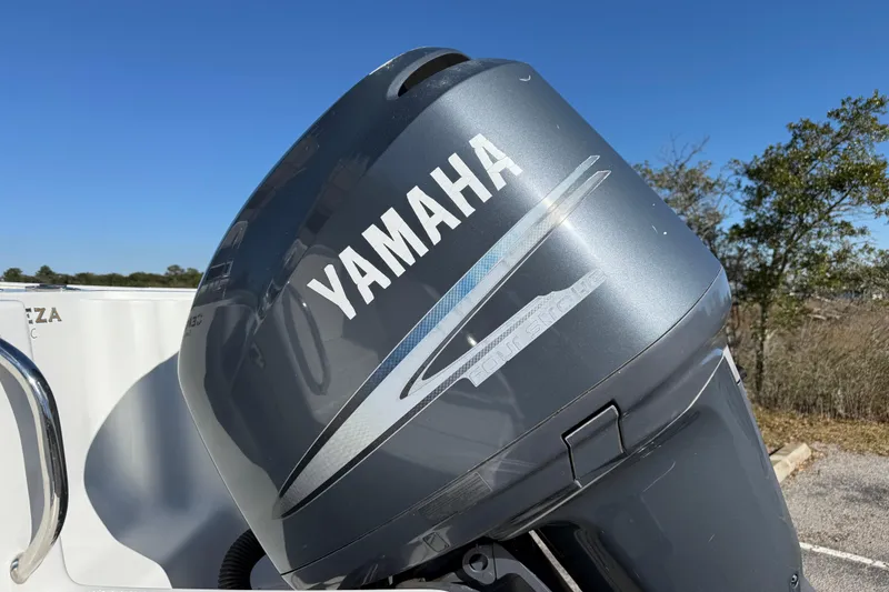 Slide: The Image of Yamaha outboard motor on 2005 Sailfish 218 CC boat under clear blue sky. - 14
