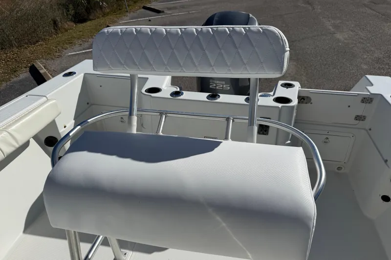 Slide: The Image of 2005 Sailfish 218 CC boat interior with white seating and Yamaha 225 engine. - 21