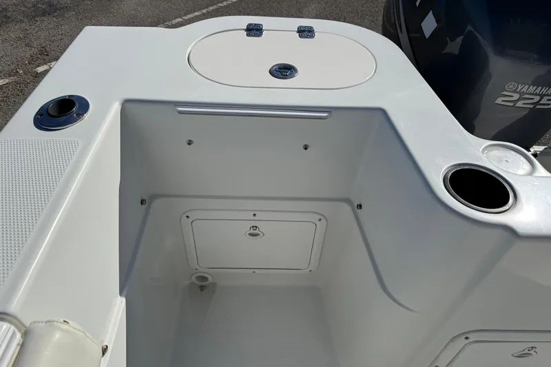 Slide: The Image of 2005 Sailfish 218 CC boat interior with storage compartment and Yamaha 225 engine. - 25