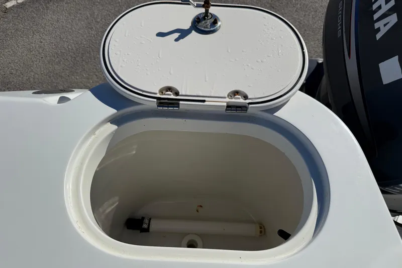 Slide: The Image of Open hatch on 2005 Sailfish 218 CC boat, revealing storage compartment. - 26