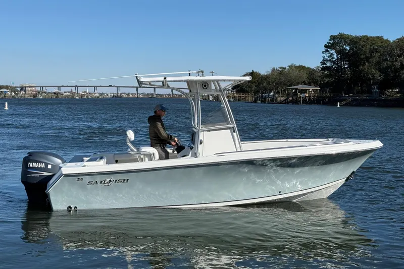 Slide: The Image of 2005 Sailfish 218 CC boat on water with Yamaha engine, clear sky background. - 3