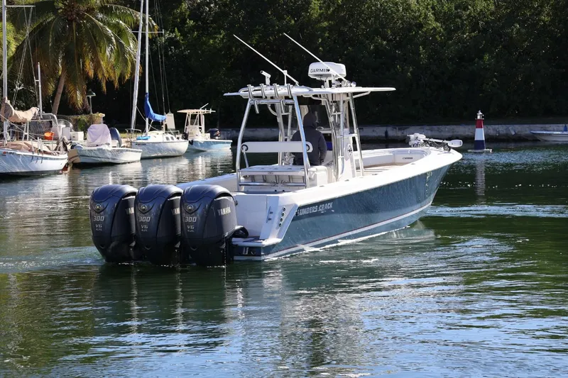 Slide: The Image of 2007 Contender 33 Tournament boat with triple Yamaha 300 V6 engines on water. - 2
