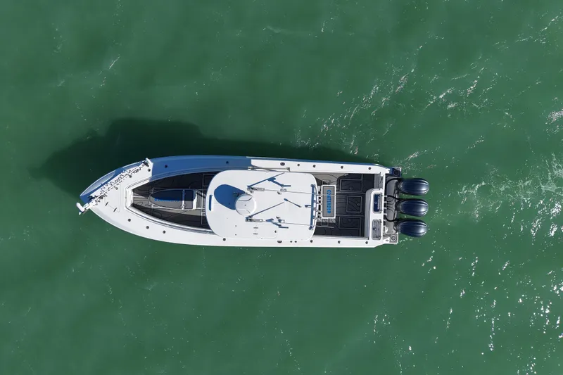 Slide: The Image of 2007 Contender 33 Tournament boat interior with speakers and storage, docked by a scenic shoreline. - 5