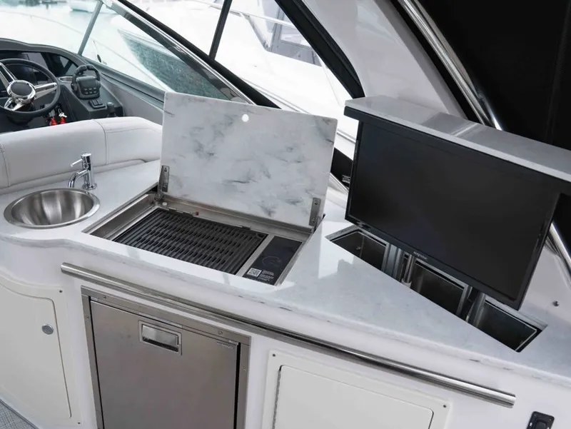 Slide: The Image of Regal 33 Express 2026 yacht kitchen with grill and sink. - 18