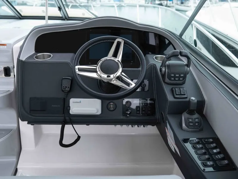 Slide: The Image of 2026 Regal 33 Express helm with modern controls and steering wheel. - 23
