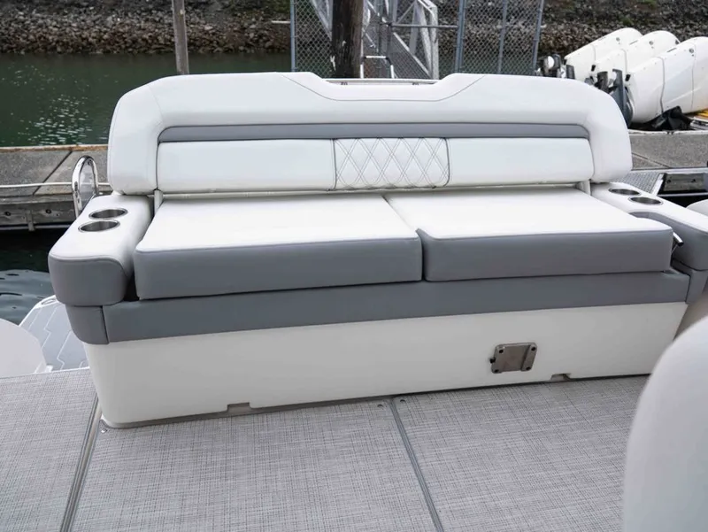 Slide: The Image of 2026 Regal 33 Express boat seating area with gray and white upholstery. - 27