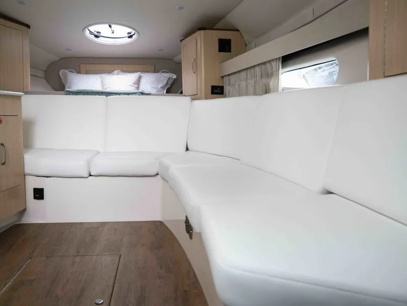 Slide: The Image of Interior of 2026 Regal 33 Express with white sofa and wood accents. - 30