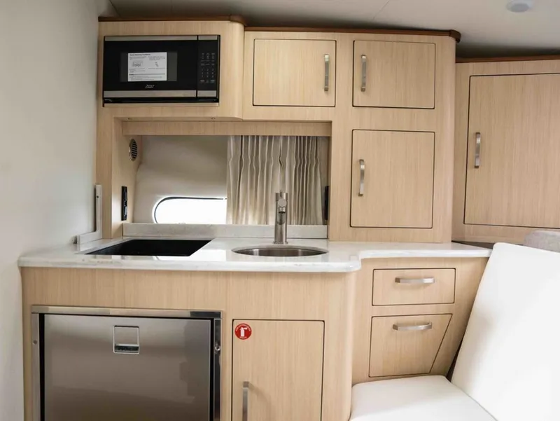 Slide: The Image of Interior of 2026 Regal 33 Express featuring modern kitchen. - 31