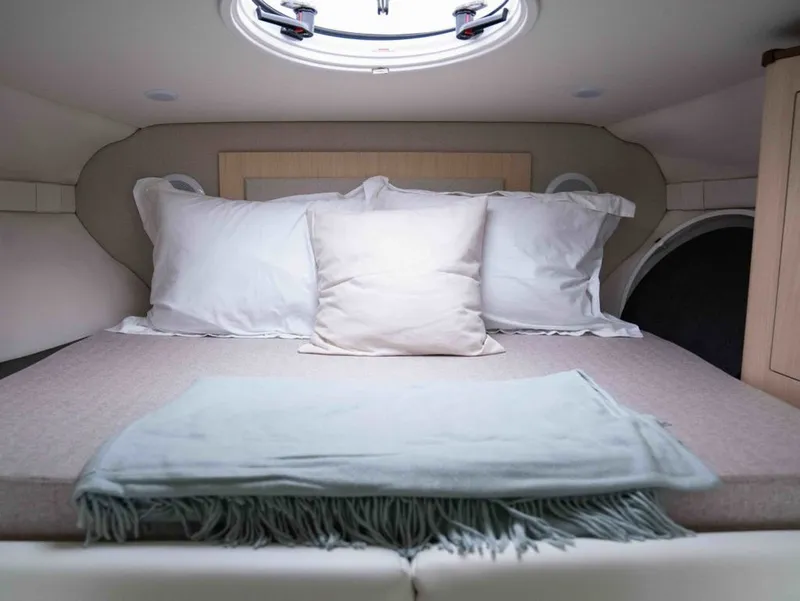 Slide: The Image of Interior of 2026 Regal 33 Express with cozy bed. - 33