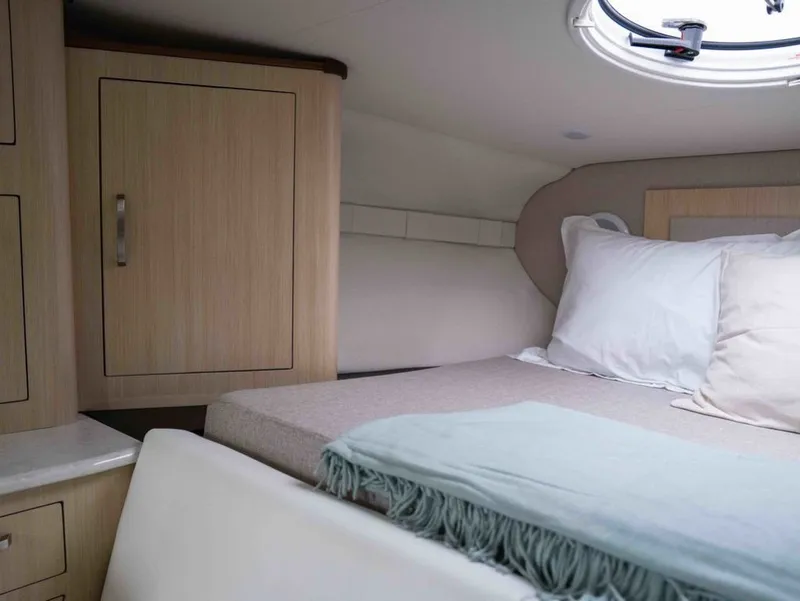 Slide: The Image of Interior of 2026 Regal 33 Express with cozy bed and cabinet. - 34