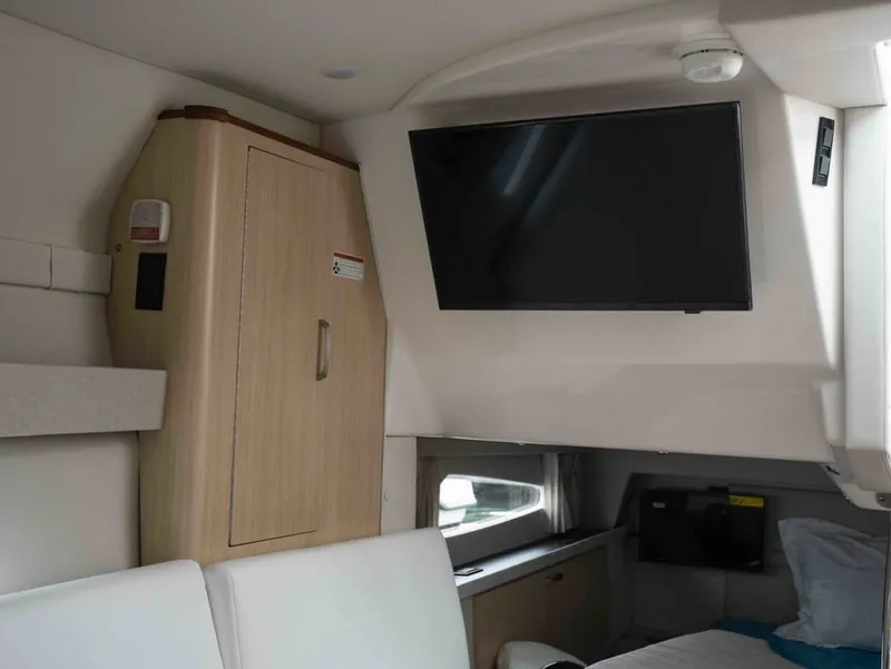Slide: The Image of Interior of 2026 Regal 33 Express with TV and cabinet. - 36