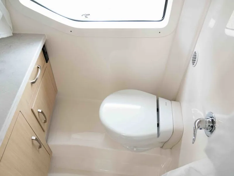 Slide: The Image of Interior of 2026 Regal 33 Express with toilet and cabinet. - 38
