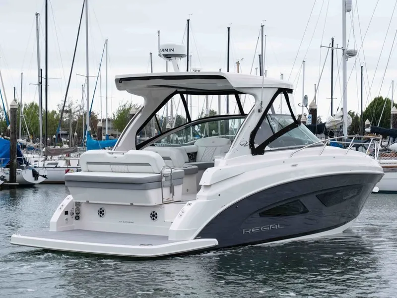 Slide: The Image of 2026 Regal 33 Express yacht docked in harbor, modern design. - 6