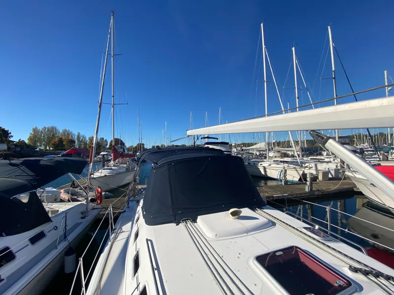 Slide: The Image of 2006 Hunter 38 sailboat docked in marina under clear sky. - 21