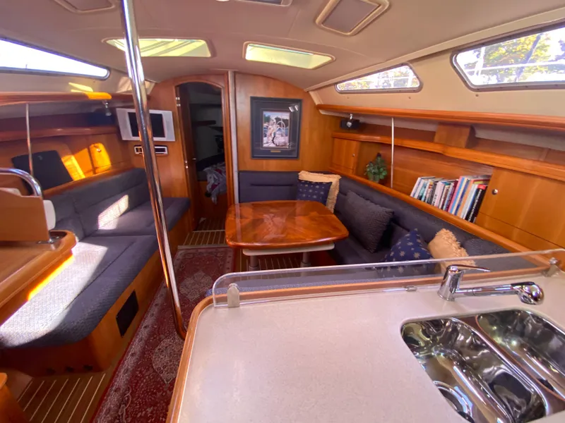 Slide: The Image of Interior of a 2006 Hunter 38 yacht with cozy seating area. - 22