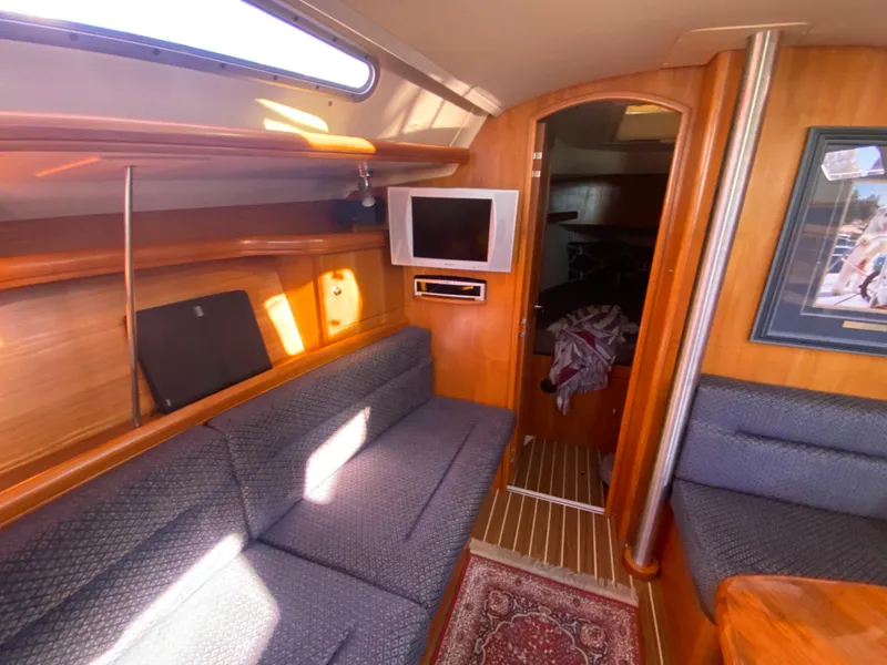 Slide: The Image of Interior of a 2006 Hunter 38 yacht with cozy sofa and TV. - 27