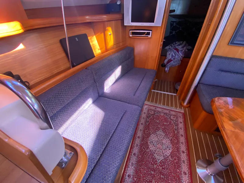 Slide: The Image of Interior of a 2006 Hunter 38 yacht with sofa and rug. - 29