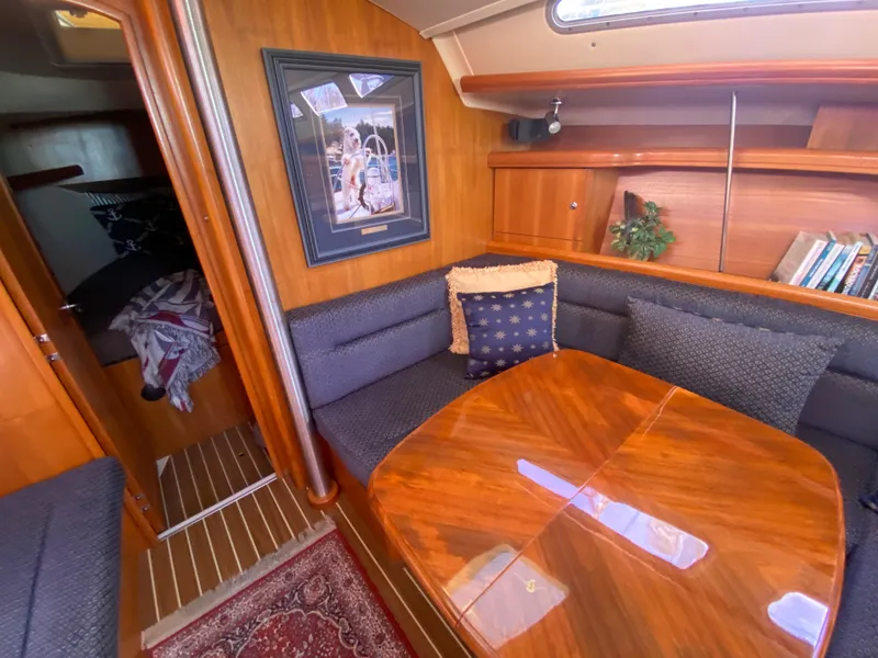 Slide: The Image of Interior of a 2006 Hunter 38 yacht with wooden table and seating area. - 30