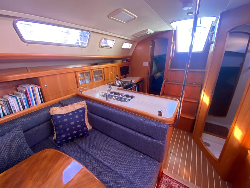 Slide: The Image of Interior of a 2006 Hunter 38 yacht with kitchen and seating area. - 31