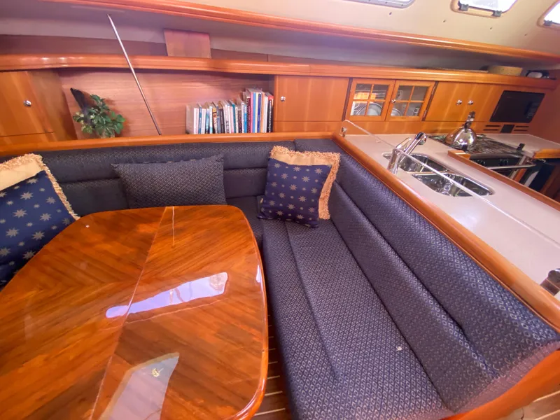 Slide: The Image of Interior of a 2006 Hunter 38 yacht with cozy seating area. - 32