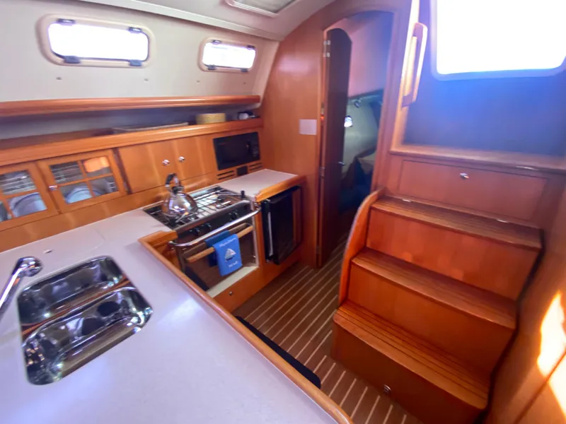 Slide: The Image of Interior of a 2006 Hunter 38 yacht with kitchen and stairs. - 36