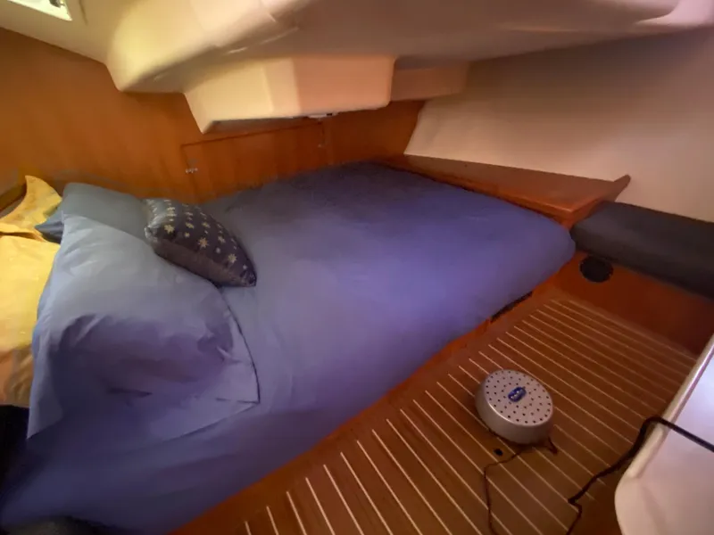 Slide: The Image of Interior of a 2006 Hunter 38 yacht with a cozy bed. - 44