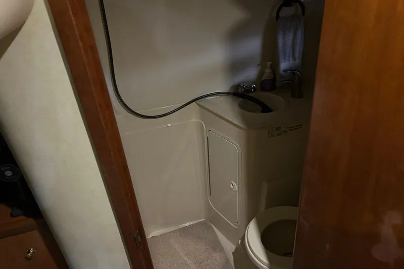 Slide: The Image of Bathroom interior of 1998 Cruisers Yachts 4270 Express, featuring compact design and amenities. - 12