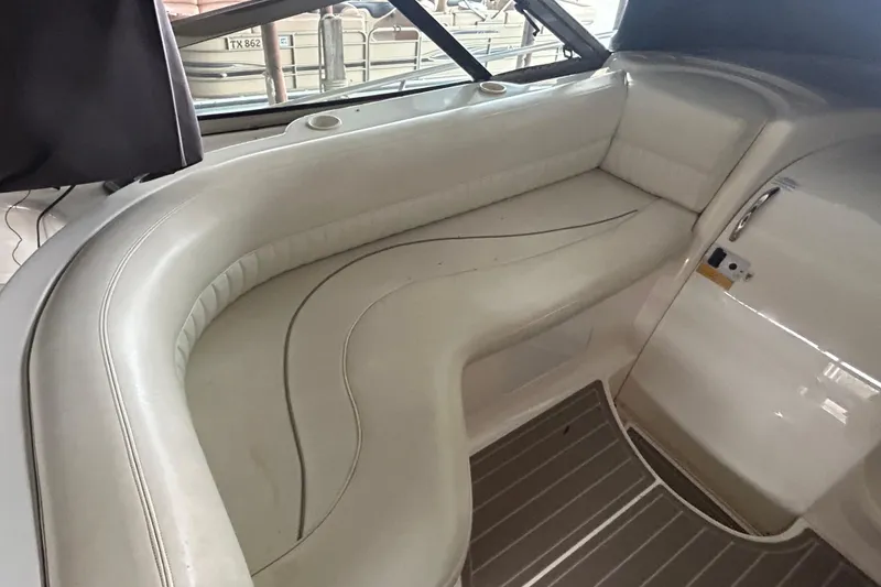 Slide: The Image of 1998 Cruisers Yachts 4270 Express interior seating area with white upholstery. - 15