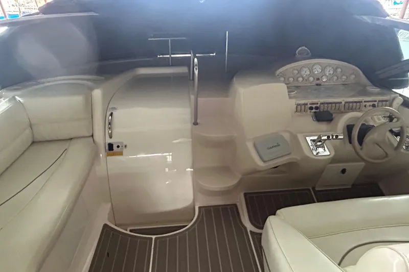 Slide: The Image of 1998 Cruisers Yachts 4270 Express cockpit with steering wheel and control panel. - 16