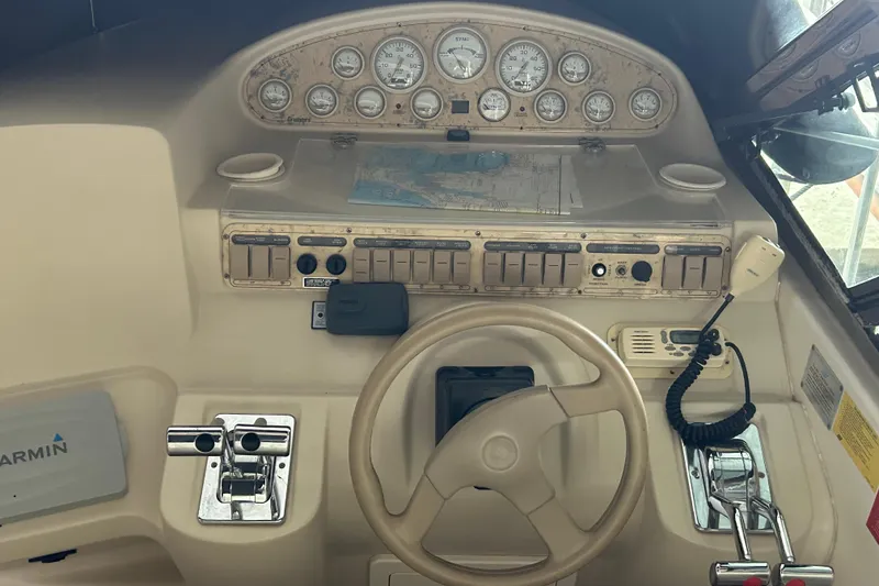 Slide: The Image of 1998 Cruisers Yachts 4270 Express helm with gauges, controls, and navigation equipment. - 17