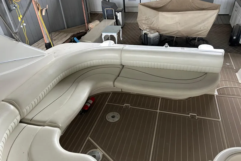 Slide: The Image of 1998 Cruisers Yachts 4270 Express interior with beige seating and wooden flooring. - 21