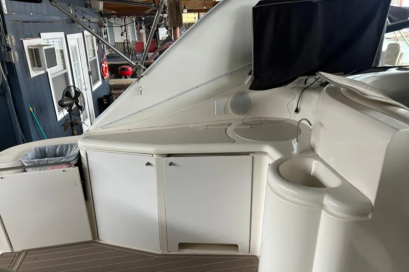 Slide: The Image of 1998 Cruisers Yachts 4270 Express interior with cabinets and sink. - 22