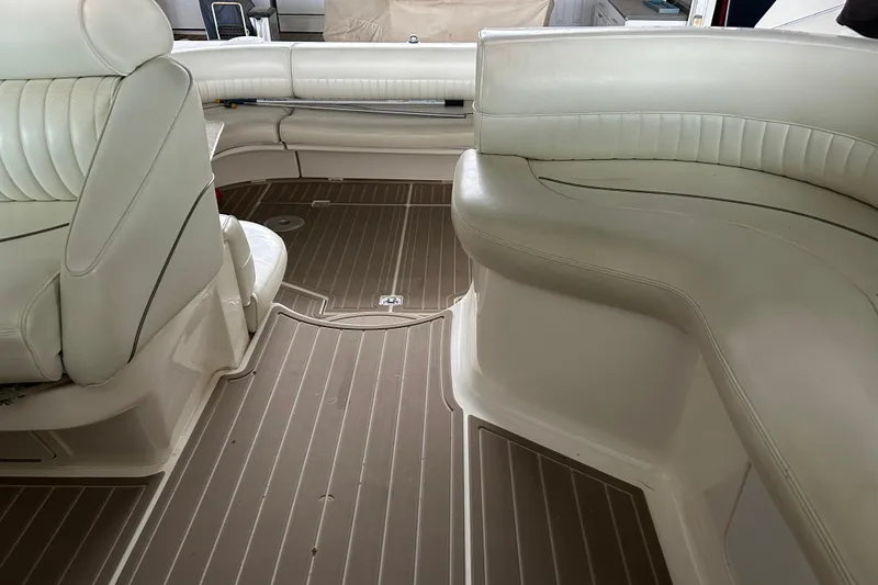 Slide: The Image of 1998 Cruisers Yachts 4270 Express interior with white seating and brown flooring. - 3