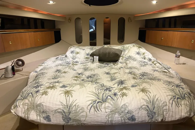 Slide: The Image of Luxurious cabin interior of 1998 Cruisers Yachts 4270 Express with cozy bedding. - 6