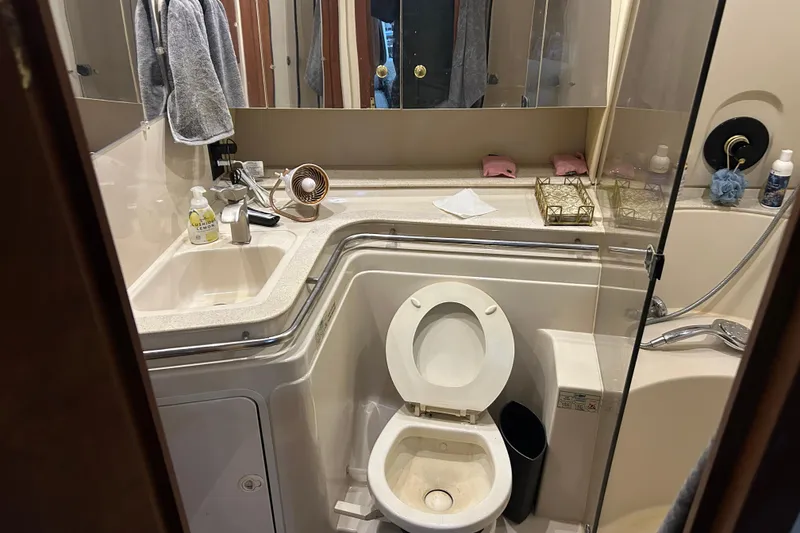 Slide: The Image of Bathroom interior of 1998 Cruisers Yachts 4270 Express with sink, toilet, and shower. - 8