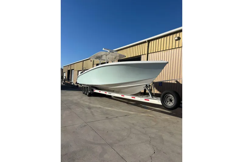 The Image of 2017 Venture 39 Open boat on trailer outside a warehouse. - 0