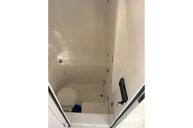 Slide: The Image of 2017 Venture 39 Open boat interior bathroom with toilet and compact design. - 10