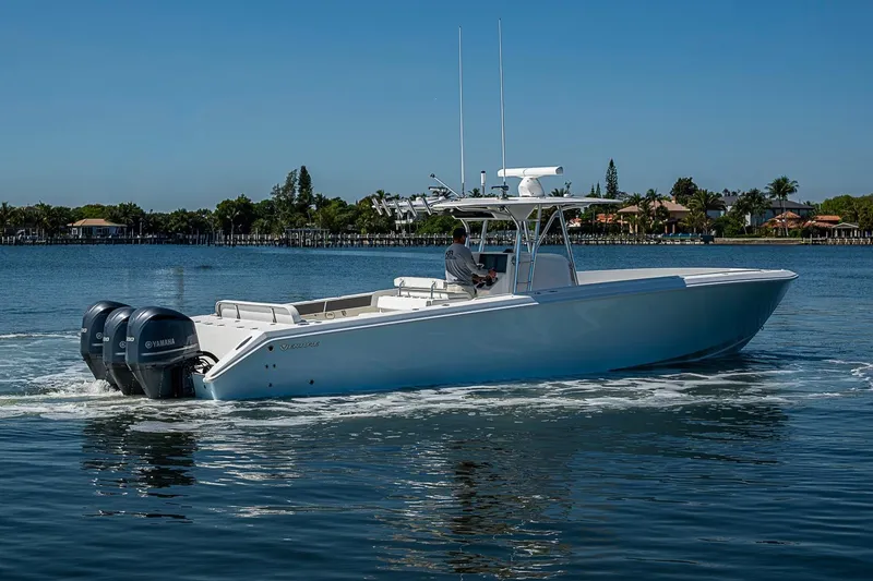 Slide: The Image of 2017 Venture 39 Open boat cruising on a calm waterway with twin Yamaha engines. - 13