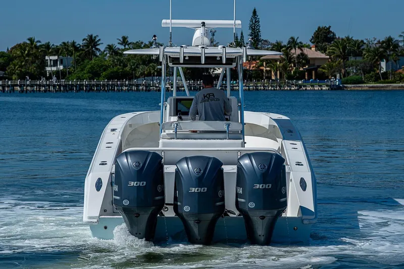 Slide: The Image of 2017 Venture 39 Open boat with triple Yamaha 300 engines on calm water. - 15